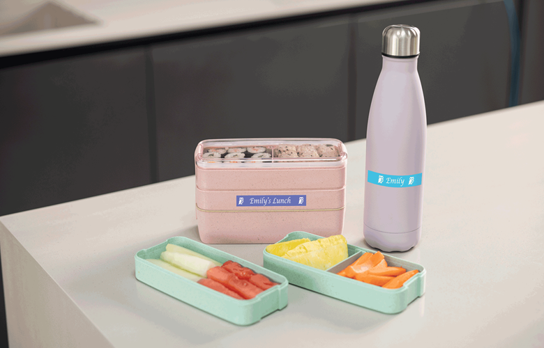 Bento box and drink bottle labelled with name tags using Btag colour labels 