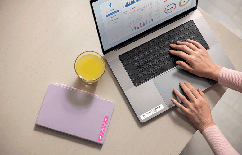 Laptop and notepad labelled by home worker using Btag coloured labels 